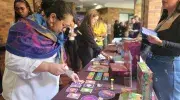 Participantes del  II Foro Andino Por la Salud de Ellas visitando e interactuando en el stand de juegos educativos salud sexual y reproductiva de la Javeriana Cali